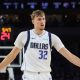 Dallas Mavericks rookie Cooper Flagg reacts during a game.