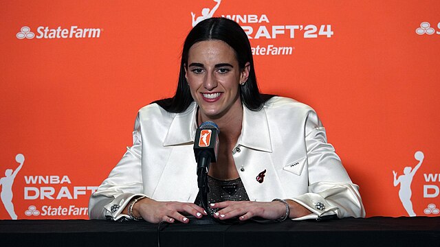 Caitlin Clark answers questions at her press conference moments after being selected first in the 2024 WNBA Draft. Photo credits: Wikimedia Commons
